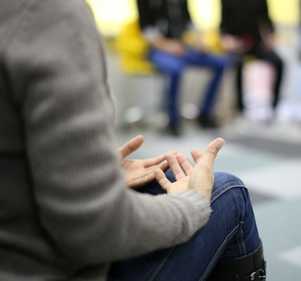 three people sitting on chairs